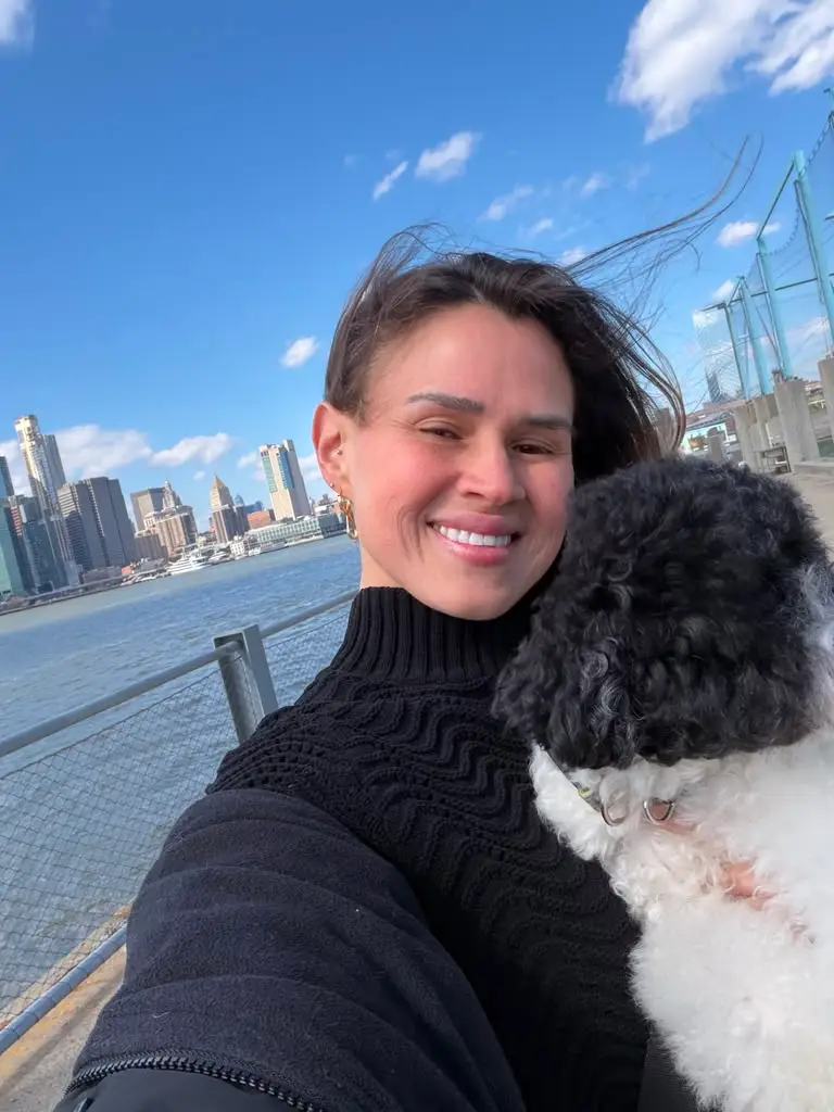 Adriana and a dog by the Manhattan skyline