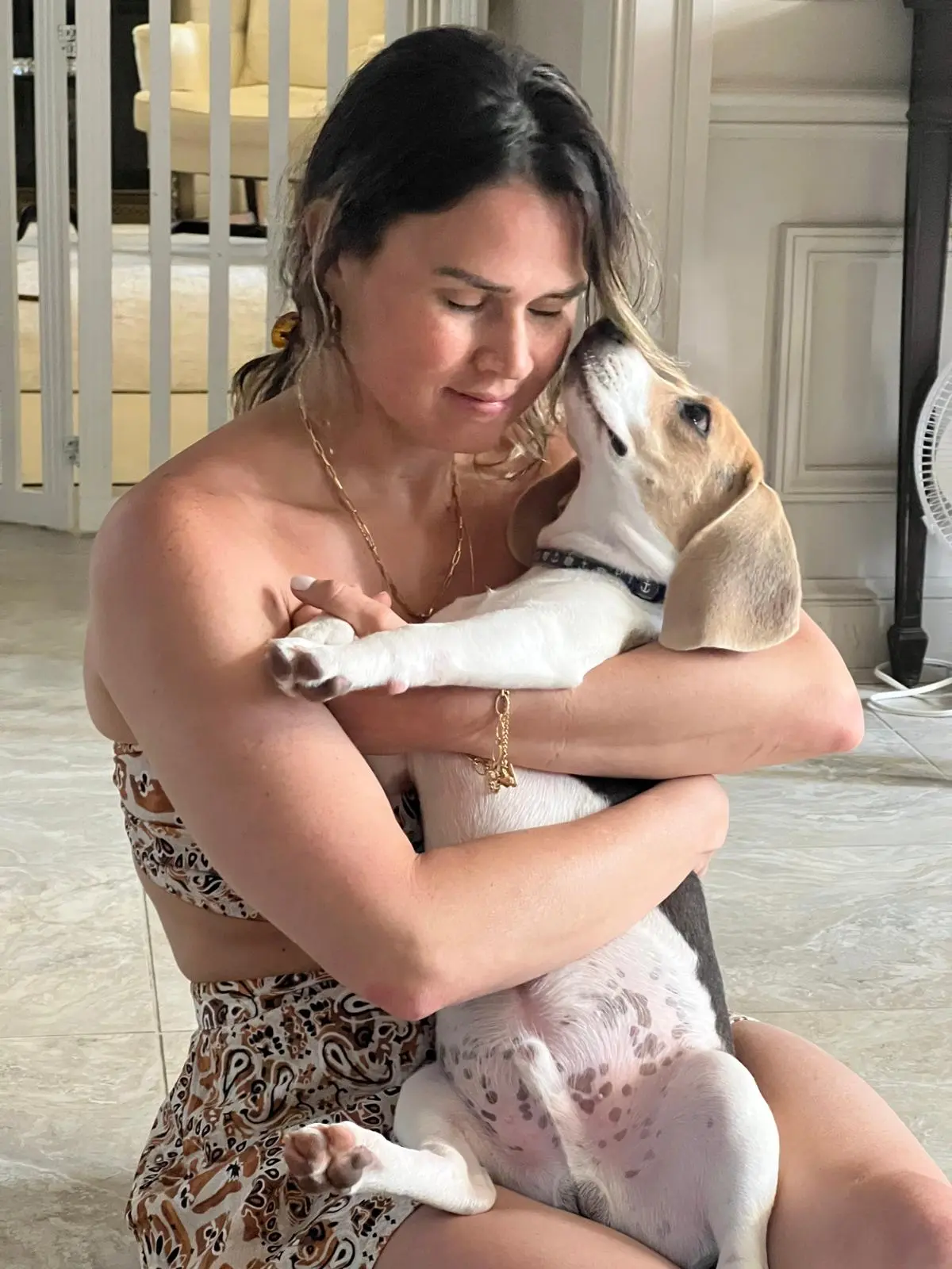Adriana hugging a beagle puppy