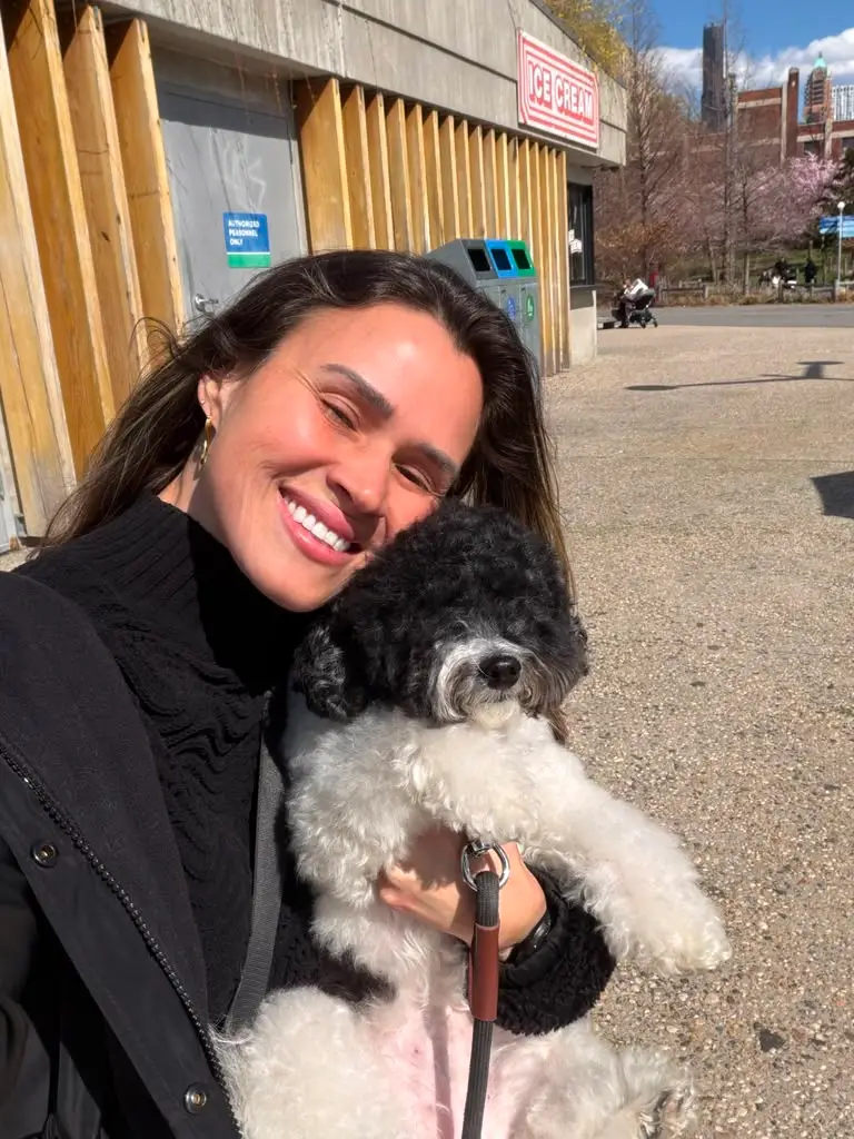 Adriana with a poodle outdoors